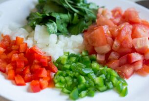 Colorful diced vegetables on a plate, perfect for healthy cooking and meal prep.