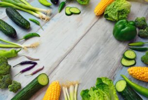 An assortment of fresh vegetables on a wooden table, perfect for healthy cooking.