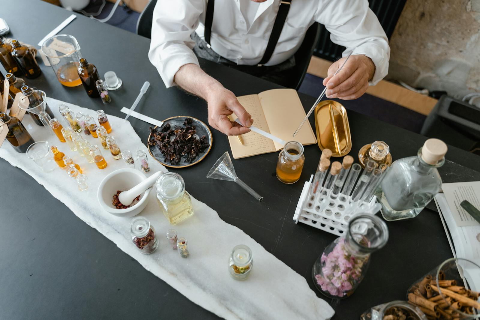 A detailed setup of an artisanal perfume-making process in a laboratory environment.