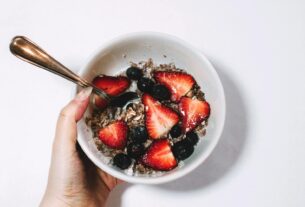 Fresh muesli with strawberries and blueberries, a perfect healthy breakfast.