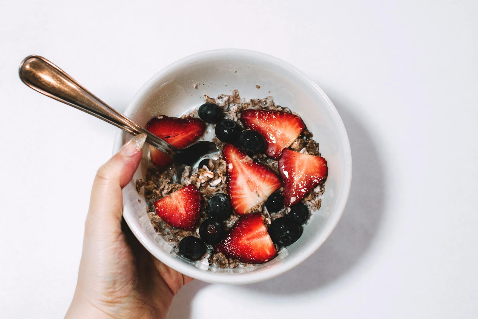 Fresh muesli with strawberries and blueberries, a perfect healthy breakfast.