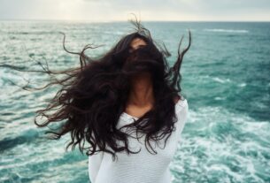 woman standing near body of water during daytime